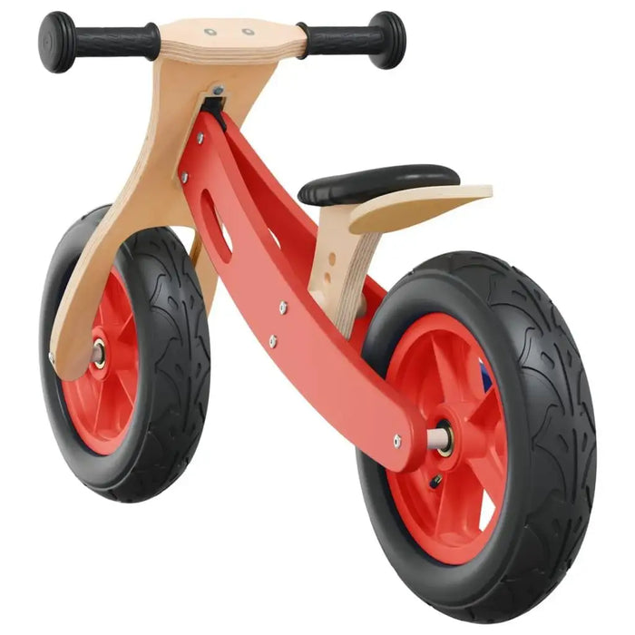 Red balance bike with adjustable seat, wooden frame, and black handlebars