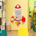 Space-themed wooden rocket activity board mounted on classroom wall with colorful gears and shapes