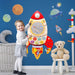 Girl playing with rocket-shaped wooden space activity board on blue wall with planets