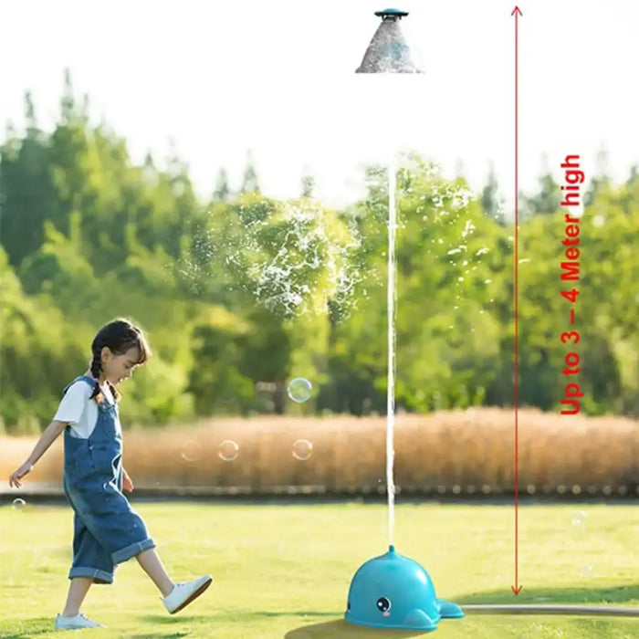 Girl playing near spinning whale water sprinkler spraying up to 3-4 meters on grass lawn