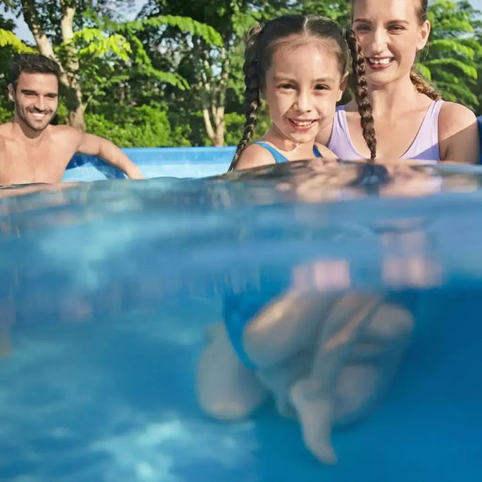 Family smiling in Bestway Steel Pro above ground swimming pool outdoors