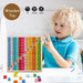 Child playing with colorful wooden multiplication table learning blocks on a table.