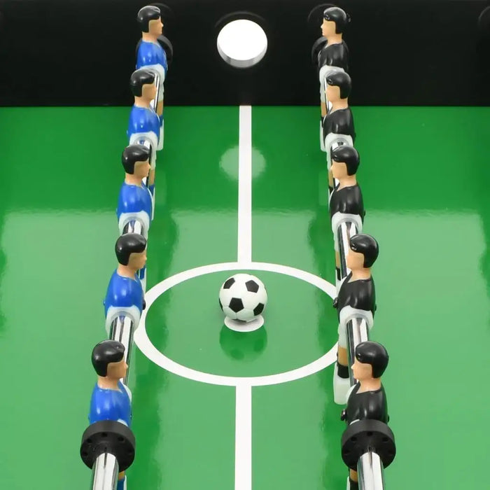 Foosball game table with blue and black player figures and a soccer ball on green field