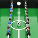 Foosball game table with blue and black player figures and a soccer ball on green field