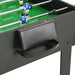 Close-up of black multi-game table with foosball player rods on green playing surface