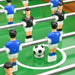 Close-up of foosball table game with blue and black player figures and soccer ball on green field