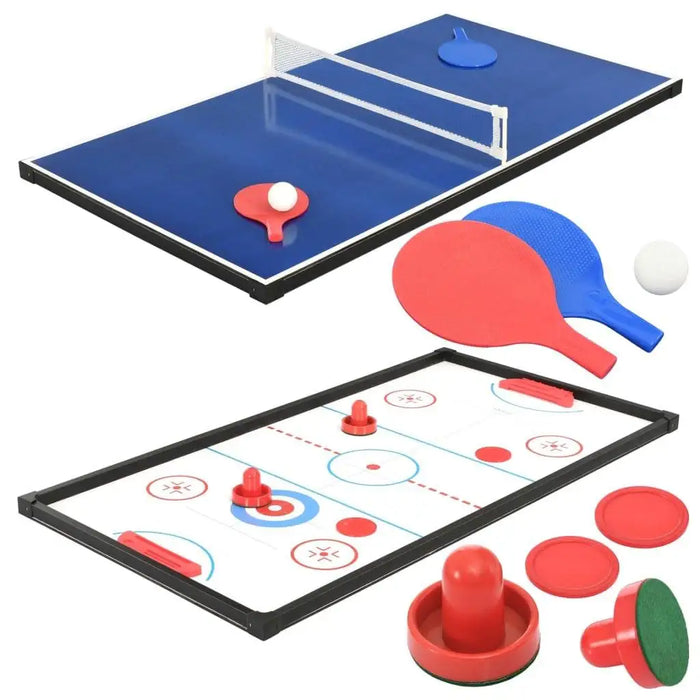 Multi-game table with air hockey and table tennis, paddles, pucks, and balls on white background