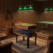 Multi game table with foosball, table tennis, and pool in a stylish wood-paneled game room