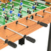 Foosball table with maple finish, black handles, and blue and black player figures