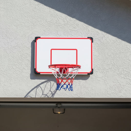 Wall-mounted basketball hoop set with red rim and blue net on outdoor stucco wall