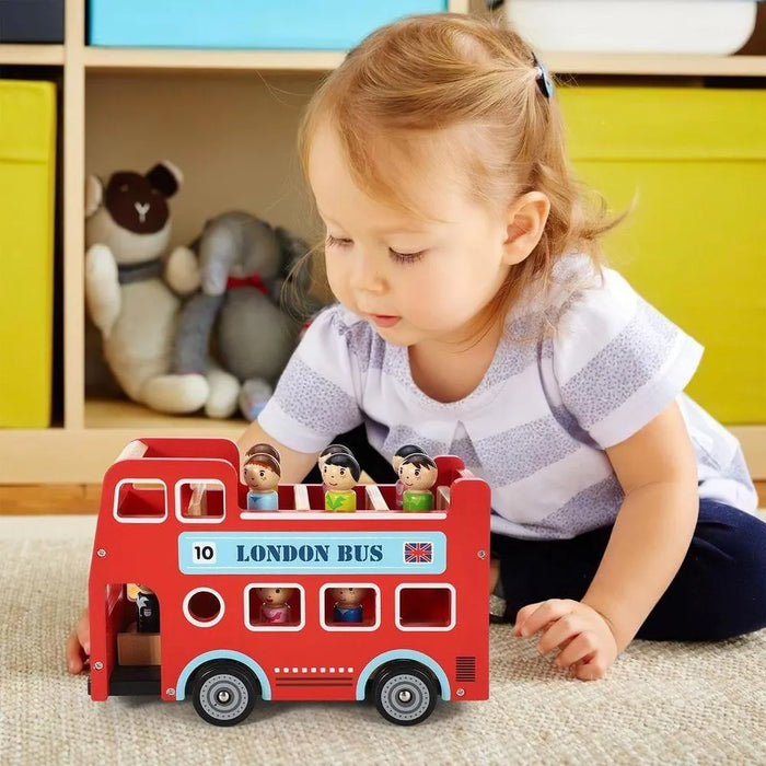 Toddler playing with wooden red double-decker London bus playset with peg passengers