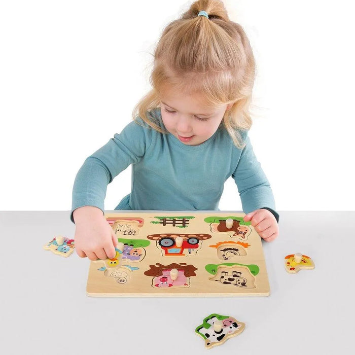 Child playing with wooden farm animals peg puzzle board featuring 7 animals and a tractor