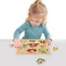 Child playing with wooden farm animals peg puzzle board featuring 7 animals and a tractor