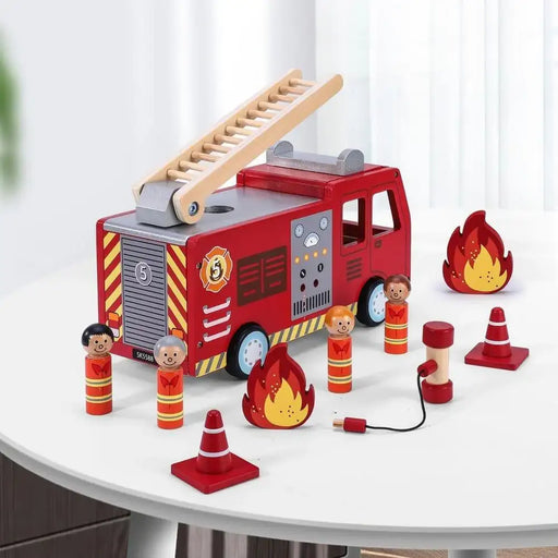 Wooden fire engine toy truck playset with ladder, four firefighter figurines, cones, and flames on a white table.