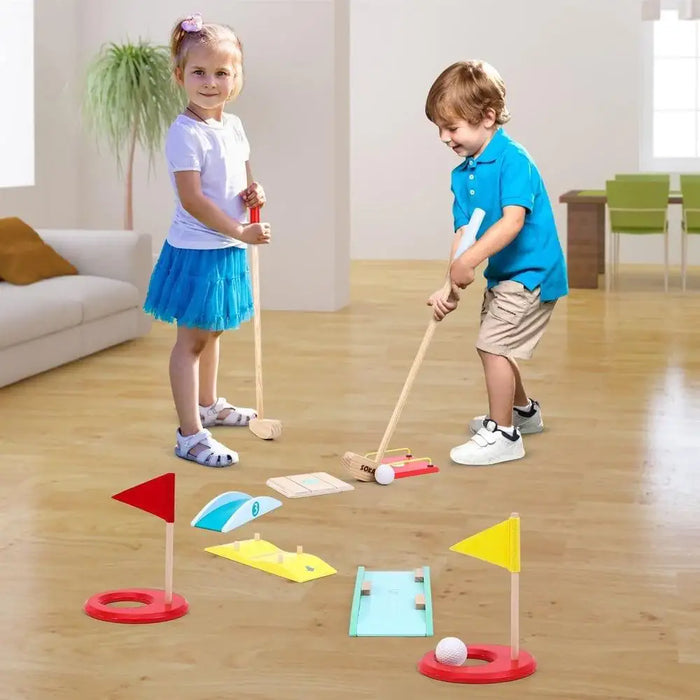 Kids playing indoors with wooden mini golf set, clubs, obstacles, and colorful flags