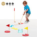 Child playing with wooden kids golf set indoors, colorful mini-golf obstacles and flags