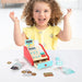 Smiling child playing with wooden kids cash register playset and pretend shop accessories