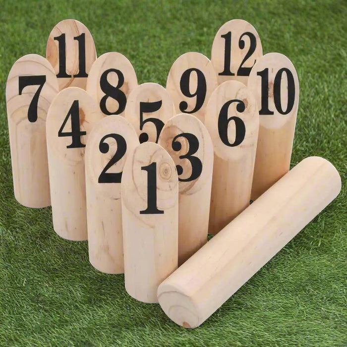 Wooden number kubb game set with 12 numbered pins and a throwing baton on grass