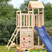 Wooden outdoor playset with slide, rock wall, and ladder in garden setting
