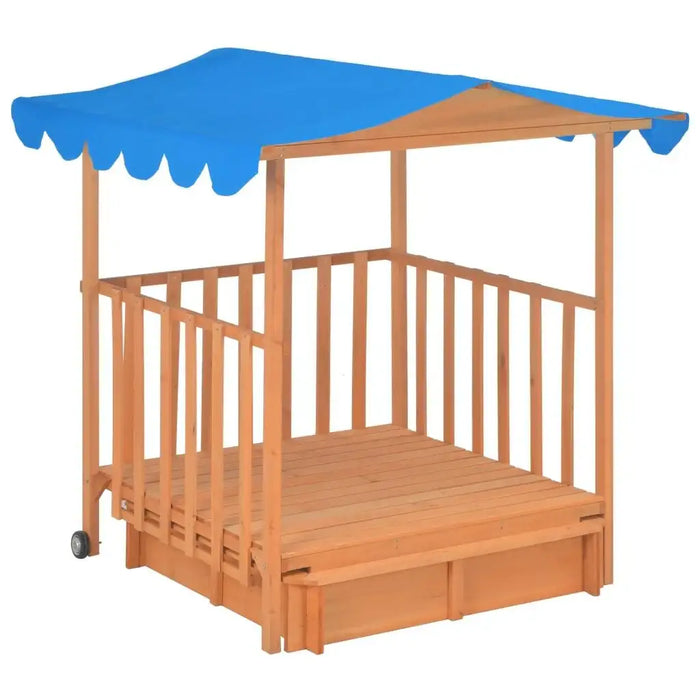 Wooden playhouse with sandbox base, blue UV50 canopy, and mobile wheels
