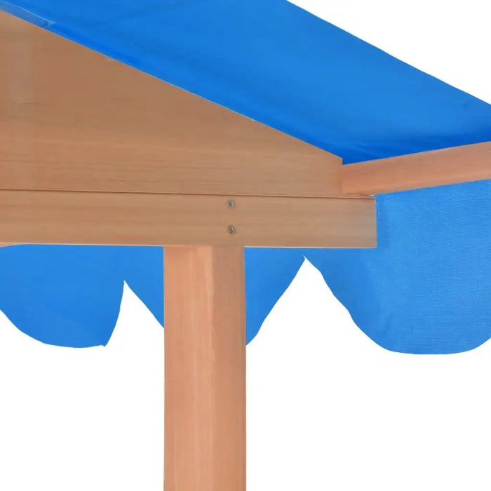 Wooden playhouse roof with blue UV50 protective canopy close-up.
