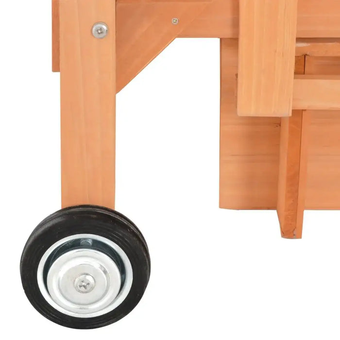Close-up of wooden playhouse frame with black wheel and metal hardware