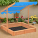 Wooden sandbox with blue adjustable UV50 roof in a garden setting, firwood construction.