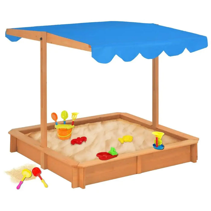 Wooden sandbox with blue adjustable roof and colorful sand toys on light sand.