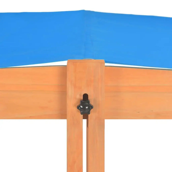 Wooden sandbox with adjustable blue UV roof and firwood construction close-up