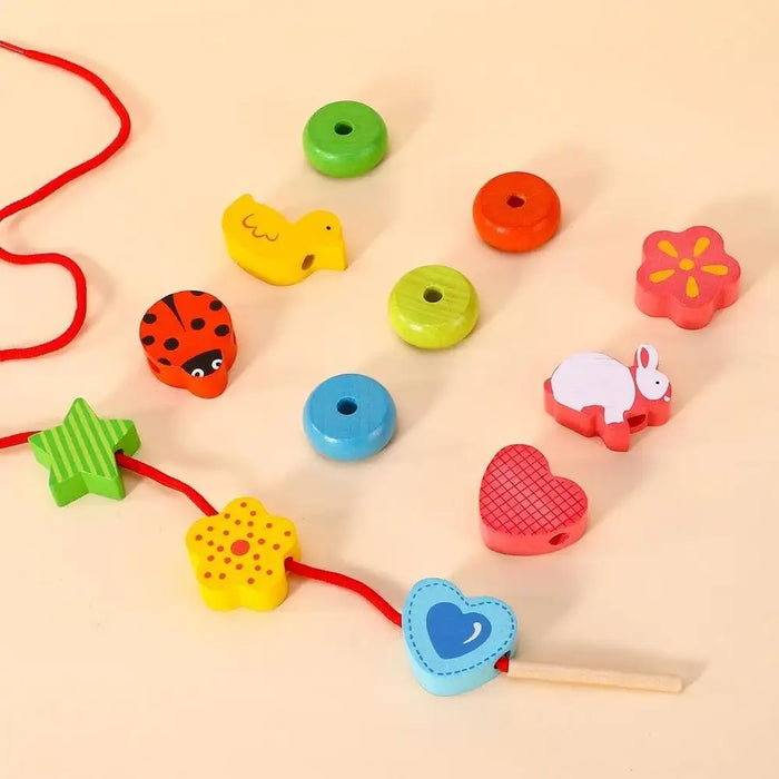 Wooden threading blocks playset with colorful animal and shape beads on a red string